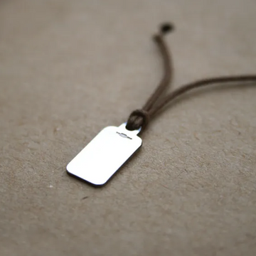 STERLING SILVER LABEL TAG ON CORD